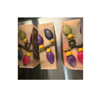 Christmas Cheer soap bars topped with colorful holiday light designs, handmade tallow soap by Tallowed Heifer