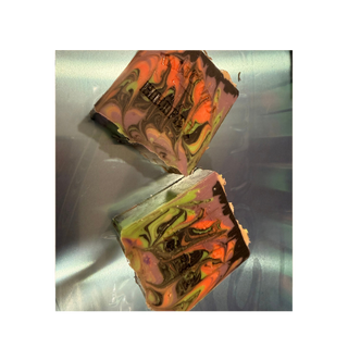 All Hallows Heifer soap bars with orange, black and green swirls, handmade goat milk soap by Tallowed Heifer